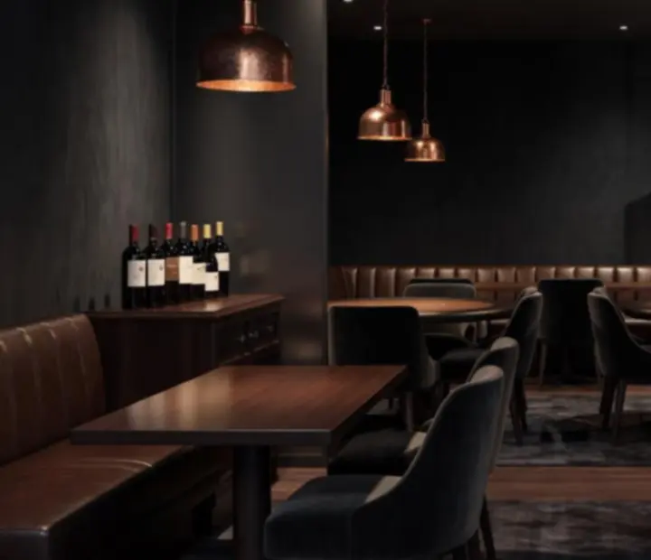 Dimly lit Australian restaurant and card lounge with poker tables, cards, chips and copper lighting