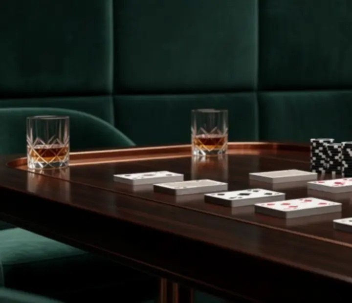 Private poker table set for dining and card play with deep forest seating and warm lighting